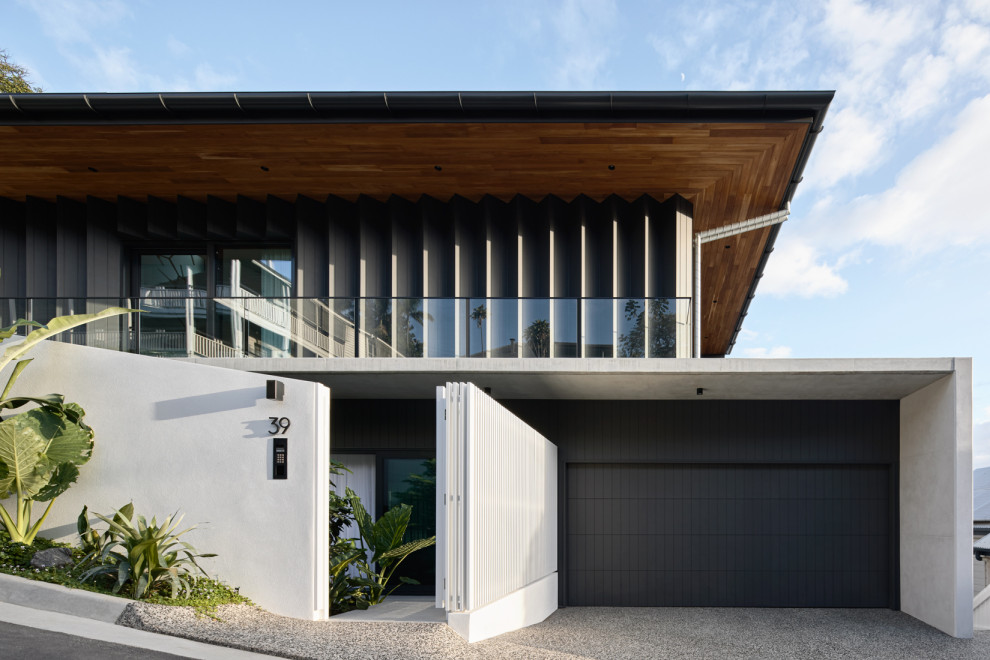 Inspiration for a medium sized and black contemporary two floor detached house in Brisbane with wood cladding.