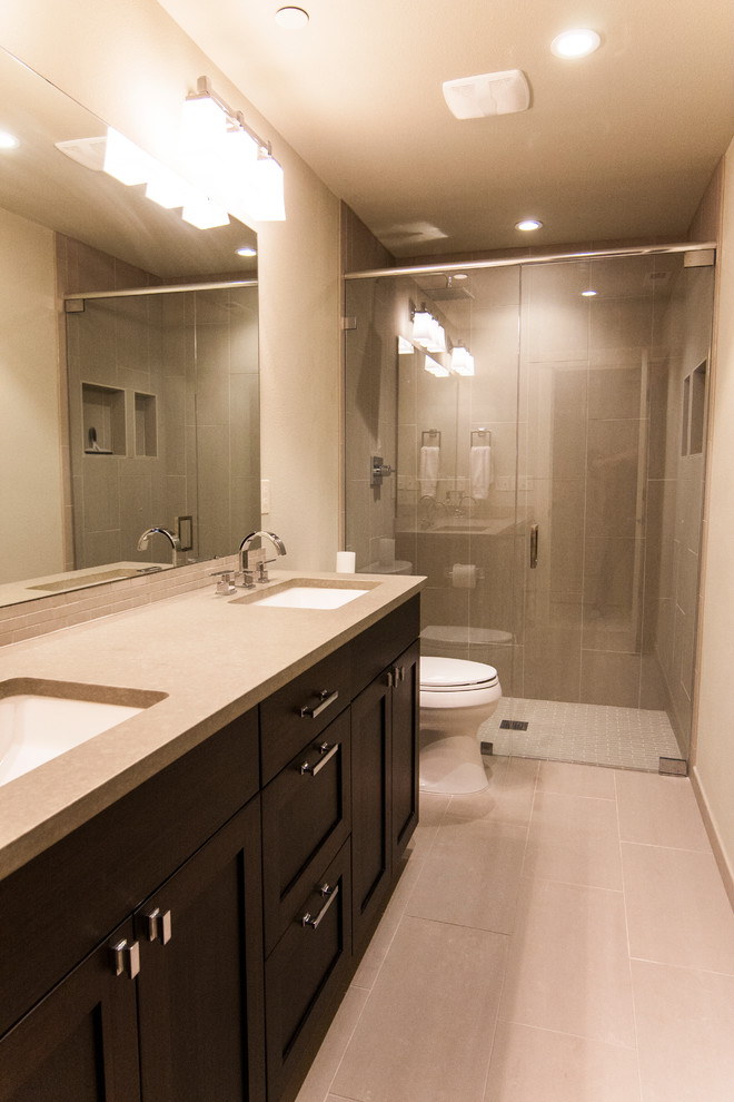Example of a minimalist gray tile and porcelain tile walk-in shower design in Seattle with an undermount sink, shaker cabinets, black cabinets, quartzite countertops and a two-piece toilet