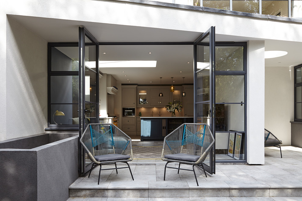 Inspiration for a contemporary backyard patio in London with concrete pavers and no cover.