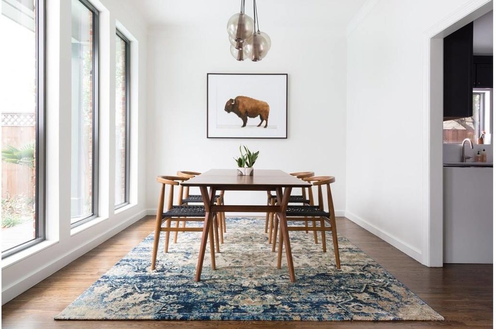 This is an example of a mid-sized contemporary separate dining room in Other with white walls, dark hardwood floors and no fireplace.