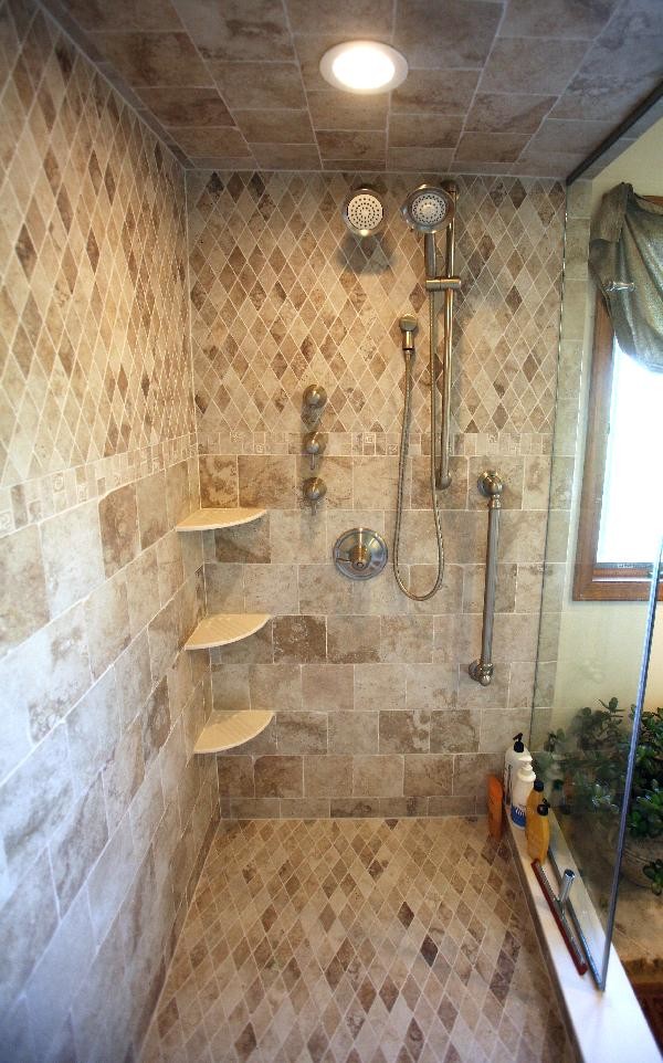 Photo of a mid-sized traditional master bathroom in New York with a corner shower, beige tile, travertine, travertine floors, beige floor and a hinged shower door.