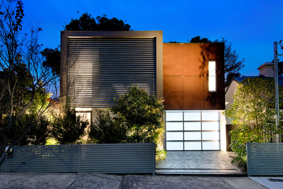 This is an example of a contemporary two-storey grey house exterior in Sydney with mixed siding and a flat roof.