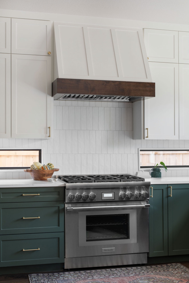 Large transitional u-shaped dark wood floor and brown floor open concept kitchen photo in Austin with an undermount sink, shaker cabinets, green cabinets, quartz countertops, white backsplash, porcelain backsplash, stainless steel appliances, a peninsula and white countertops