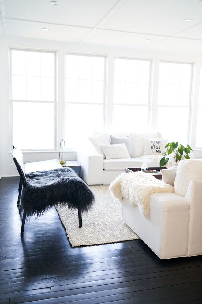 Living room library - mid-sized traditional open concept painted wood floor and black floor living room library idea in Providence with white walls, a standard fireplace, a wood fireplace surround and a media wall