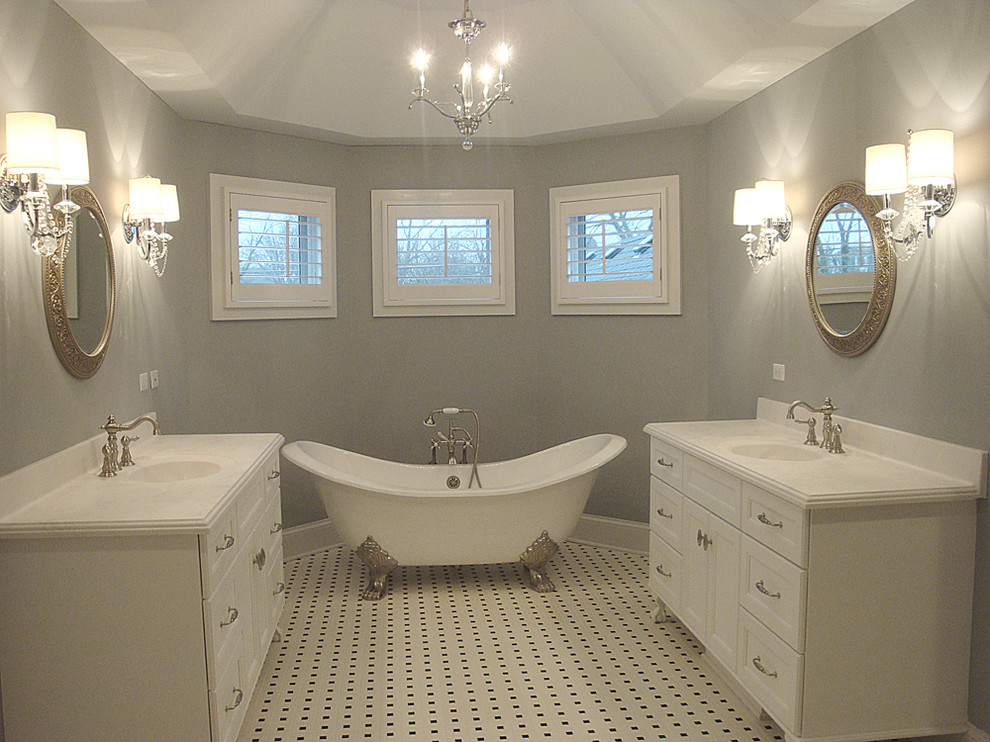 This is an example of a traditional master bathroom in Chicago with white cabinets and a claw-foot tub.