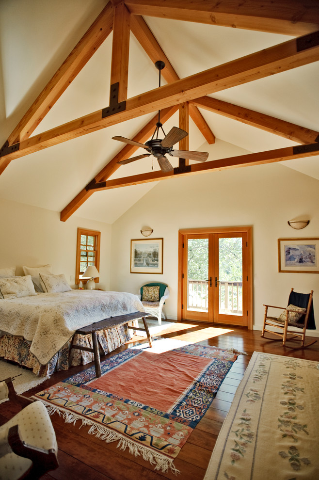 Photo of a country bedroom in San Francisco with beige walls and dark hardwood floors.