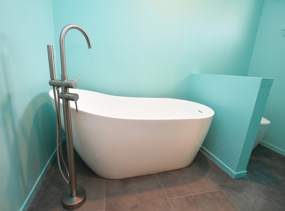 Mid-sized transitional master green tile and ceramic tile vinyl floor, gray floor and double-sink freestanding bathtub photo with shaker cabinets, light wood cabinets, a bidet, green walls, an undermount sink, quartzite countertops, a hinged shower door, white countertops and a built-in vanity