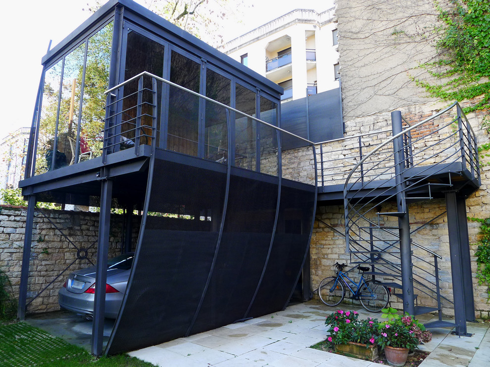 Photo of a mid-sized contemporary attached one-car carport in Dijon.