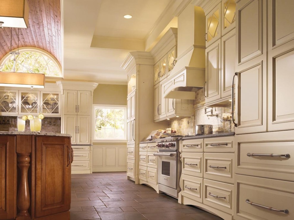 Kitchen - large kitchen idea with raised-panel cabinets, white cabinets, granite countertops, beige backsplash, subway tile backsplash, stainless steel appliances and an island