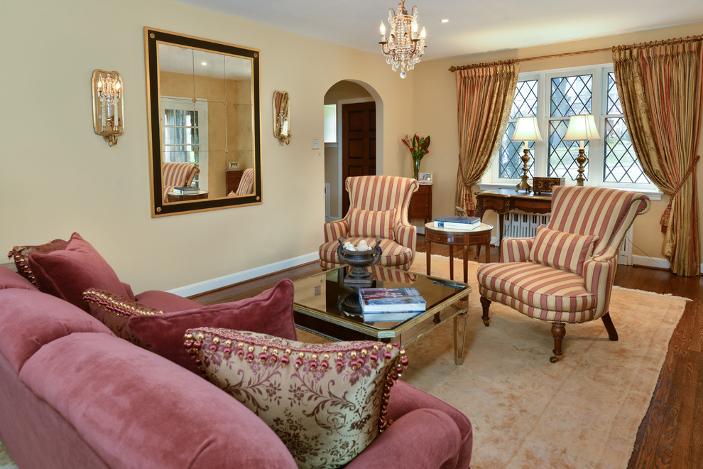 Large traditional formal living room in Philadelphia with beige walls, medium hardwood floors and a stone fireplace surround.