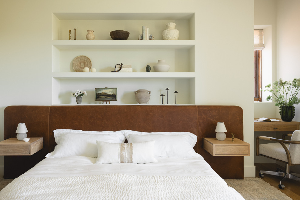 Inspiration for a mediterranean medium tone wood floor and brown floor bedroom remodel in San Luis Obispo with white walls