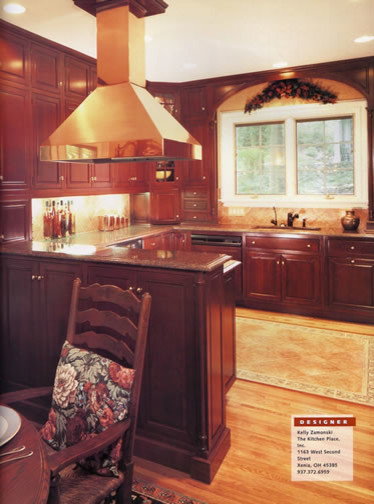 Example of a mid-sized classic u-shaped medium tone wood floor eat-in kitchen design with an undermount sink, beaded inset cabinets, dark wood cabinets, granite countertops, beige backsplash and no island