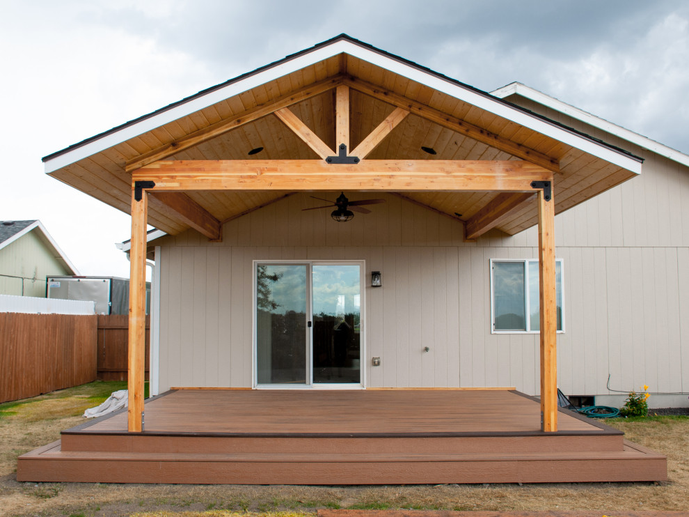 Inspiration for a mid-sized backyard deck remodel with a roof extension