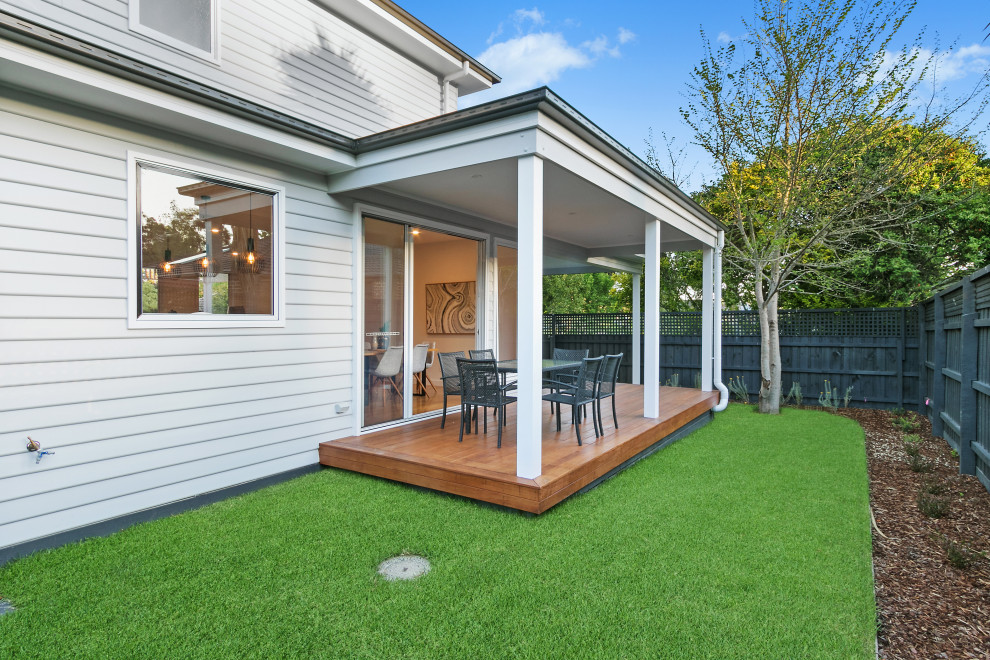 Photo of a mid-sized victorian backyard full sun xeriscape for spring in Melbourne with with lawn edging and decking.