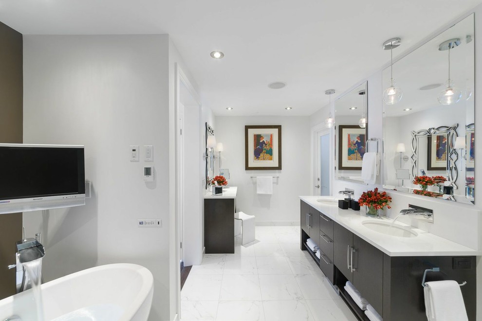 Inspiration for a large contemporary master bathroom in Ottawa with an undermount sink, flat-panel cabinets, dark wood cabinets, a freestanding tub, white tile, white walls, marble benchtops and marble floors.