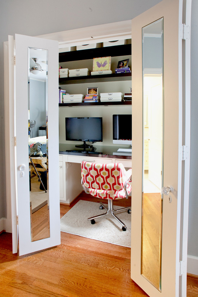 This is an example of a contemporary home office in Dallas with a built-in desk.