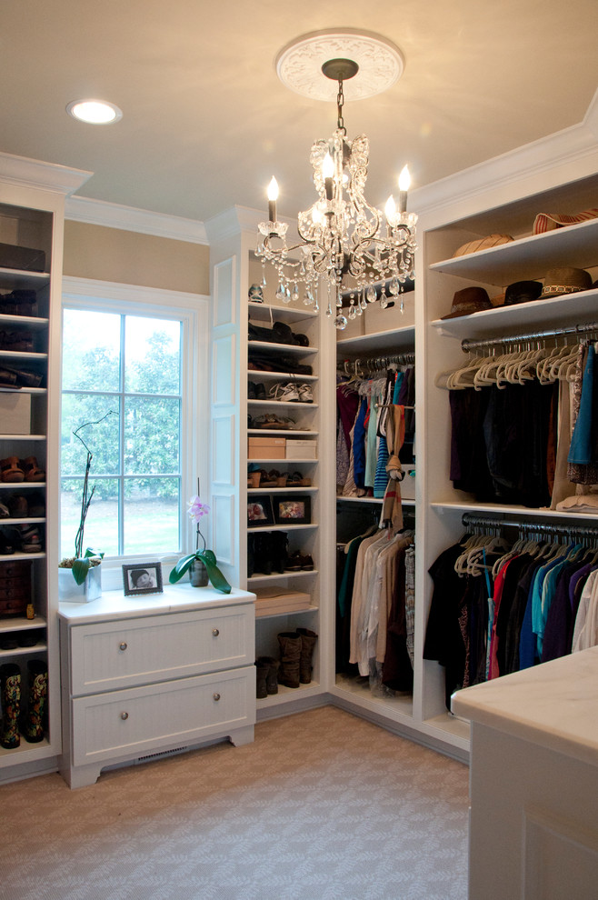 Design ideas for a large traditional women's walk-in wardrobe in Nashville with shaker cabinets, white cabinets and carpet.
