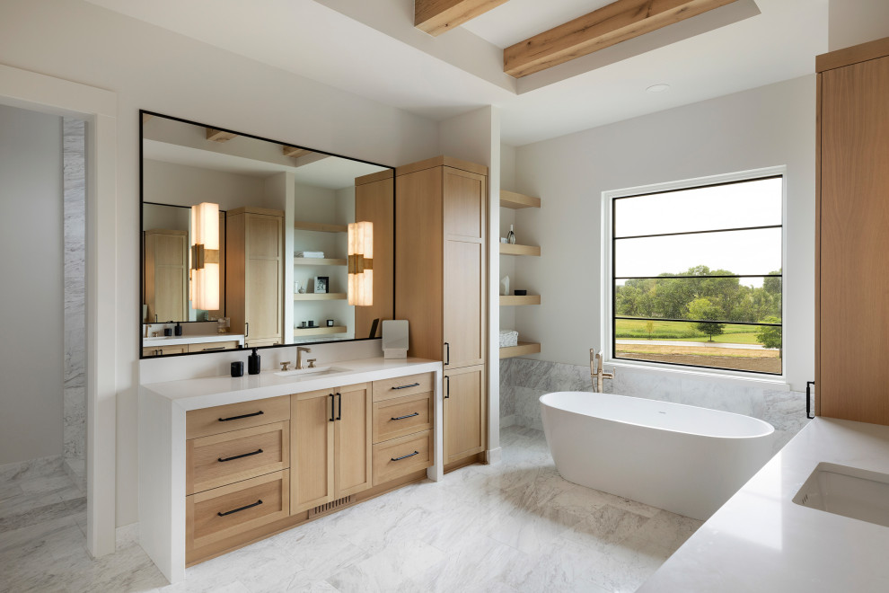 Photo of a traditional ensuite bathroom in Minneapolis with a freestanding bath, grey tiles, marble tiles, white walls, marble flooring, engineered stone worktops, grey floors, a hinged door, white worktops, an enclosed toilet, double sinks, a built in vanity unit and exposed beams.