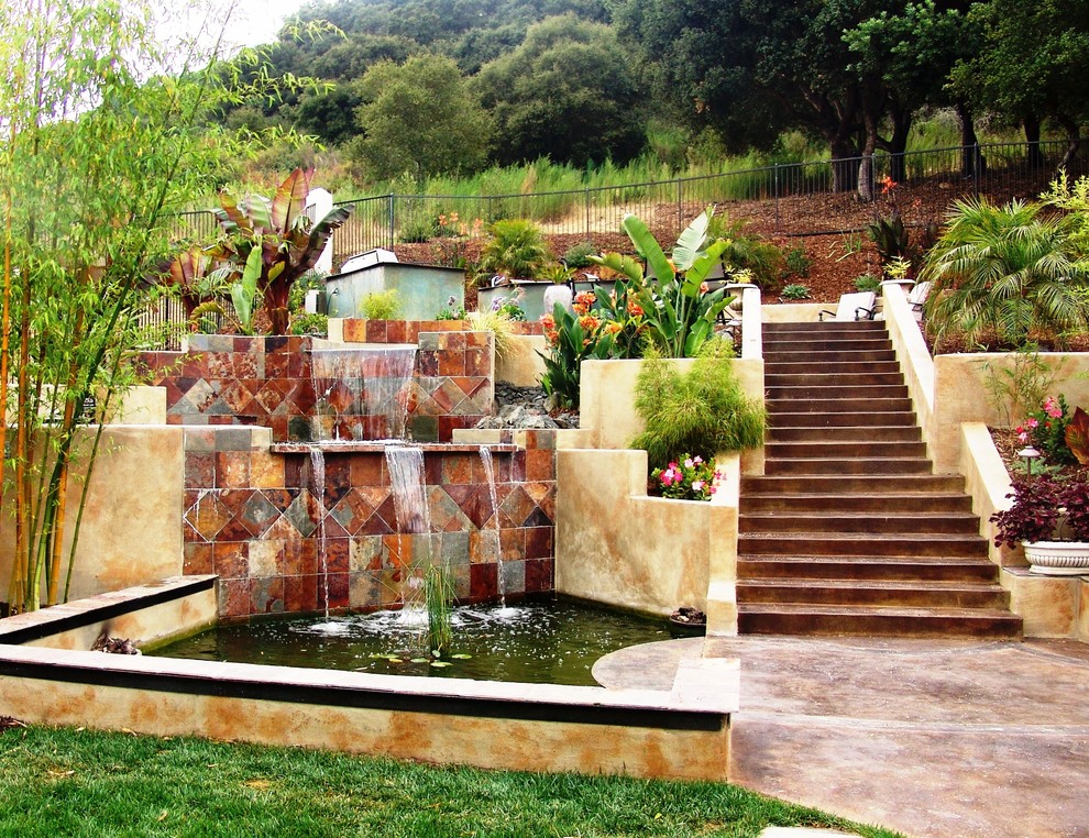 Inspiration for a large contemporary backyard rectangular pool in San Luis Obispo with a water feature and concrete slab.