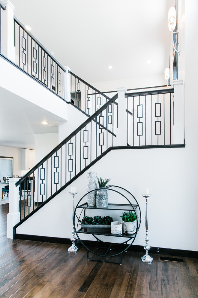 Inspiration for a mid-sized transitional u-shaped staircase in Other with metal railing.