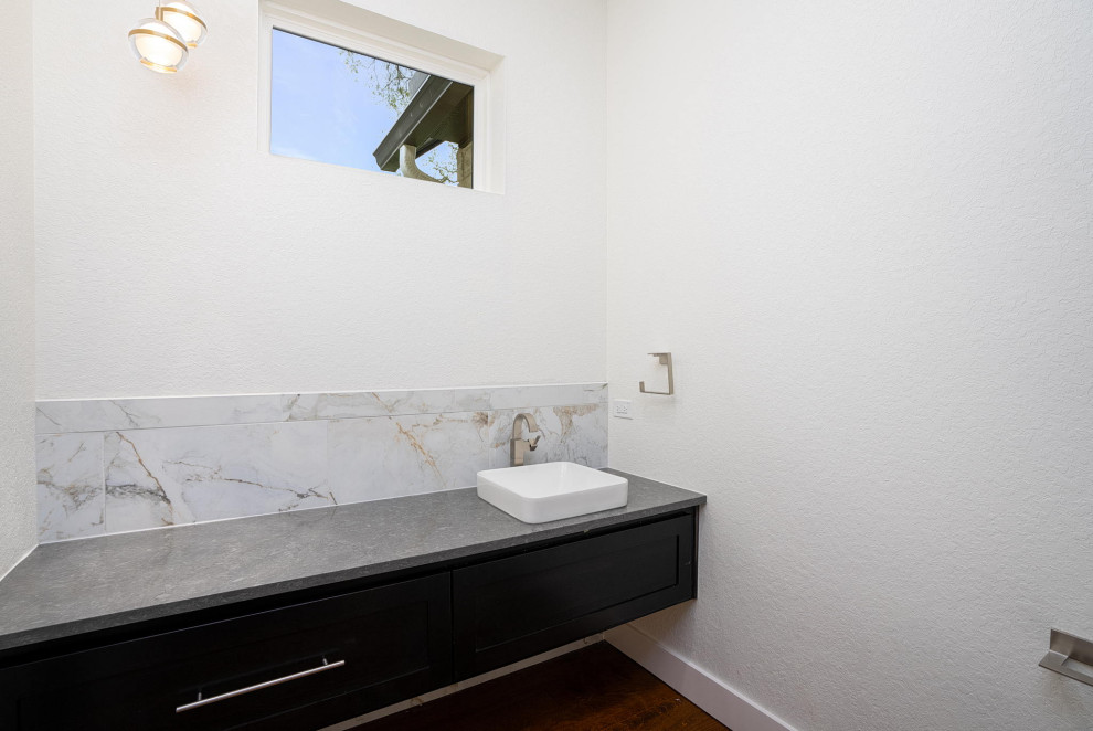 Mid-sized transitional 3/4 white tile single-sink bathroom photo in Austin with black countertops