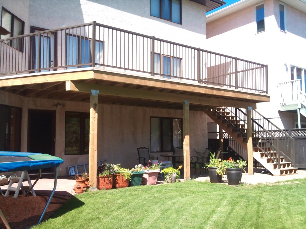 Example of a transitional backyard deck design with no cover