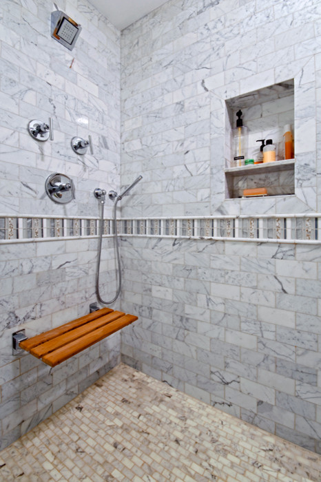 Photo of a mid-sized traditional master bathroom in DC Metro with recessed-panel cabinets, white cabinets, an alcove shower, gray tile, multi-coloured tile, white tile, stone tile, white walls, marble floors, an undermount sink and onyx benchtops.