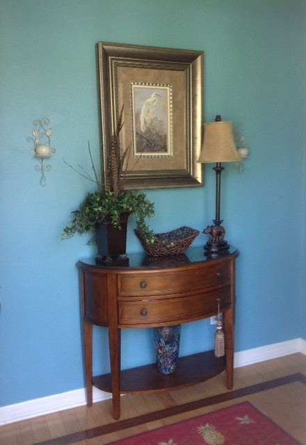 Design ideas for a small transitional foyer in Tampa with blue walls, light hardwood floors and brown floor.