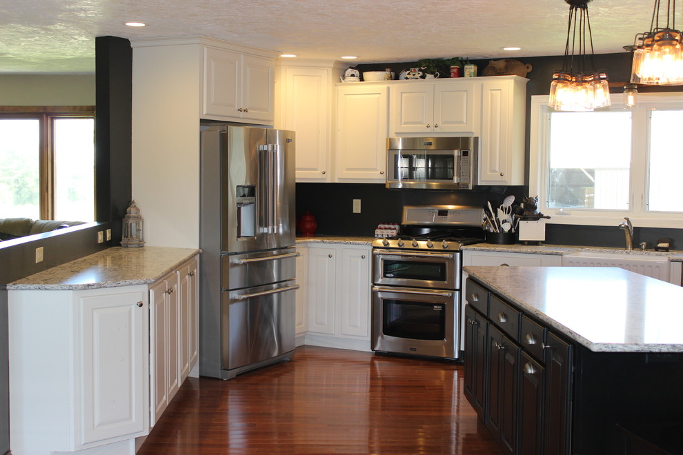 Open concept kitchen - large rustic l-shaped light wood floor open concept kitchen idea in Chicago with a farmhouse sink, raised-panel cabinets, white cabinets, quartz countertops, stainless steel appliances and an island