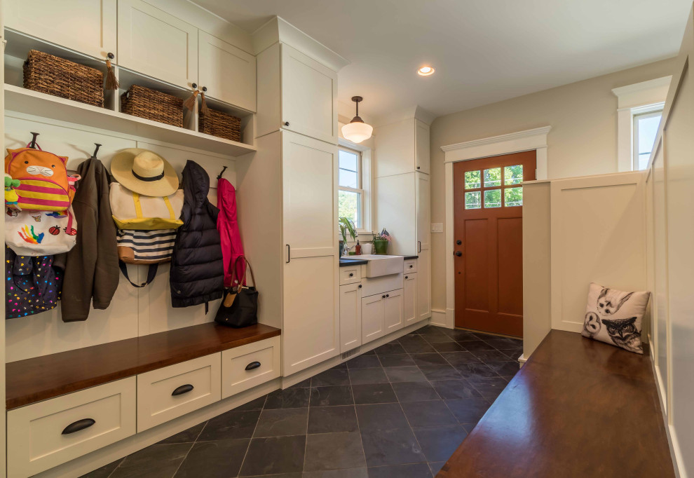 Design ideas for a mid-sized country mudroom in Chicago with beige walls, ceramic floors, a single front door, a brown front door, grey floor, wallpaper and planked wall panelling.