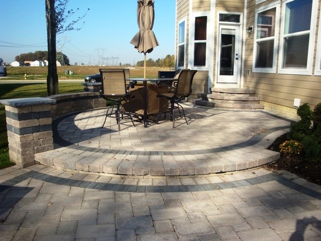 This is an example of a mid-sized contemporary backyard patio in Columbus with concrete pavers and no cover.