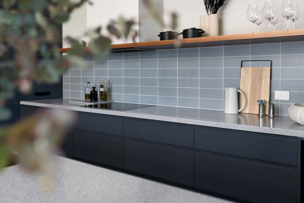 Inspiration for a mid-sized contemporary l-shaped kitchen pantry in Canberra - Queanbeyan with an undermount sink, flat-panel cabinets, blue cabinets, terrazzo benchtops, blue splashback, subway tile splashback, black appliances, laminate floors, with island, beige floor, blue benchtop and vaulted.