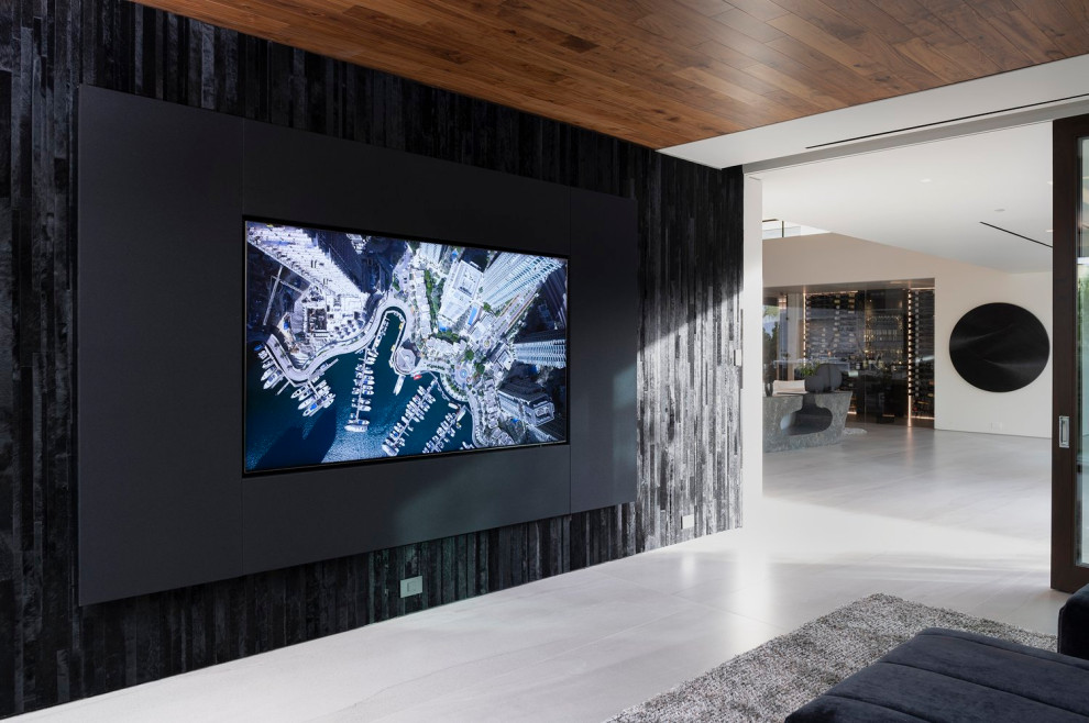 Inspiration for a medium sized modern open plan games room in Los Angeles with black walls, porcelain flooring, a wall mounted tv and white floors.