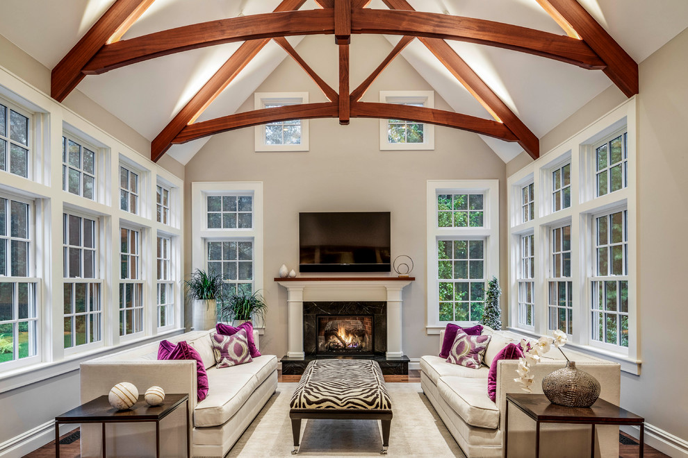Inspiration for a large transitional open concept living room in Boston with beige walls, a standard fireplace, a wood fireplace surround, a wall-mounted tv, brown floor and dark hardwood floors.