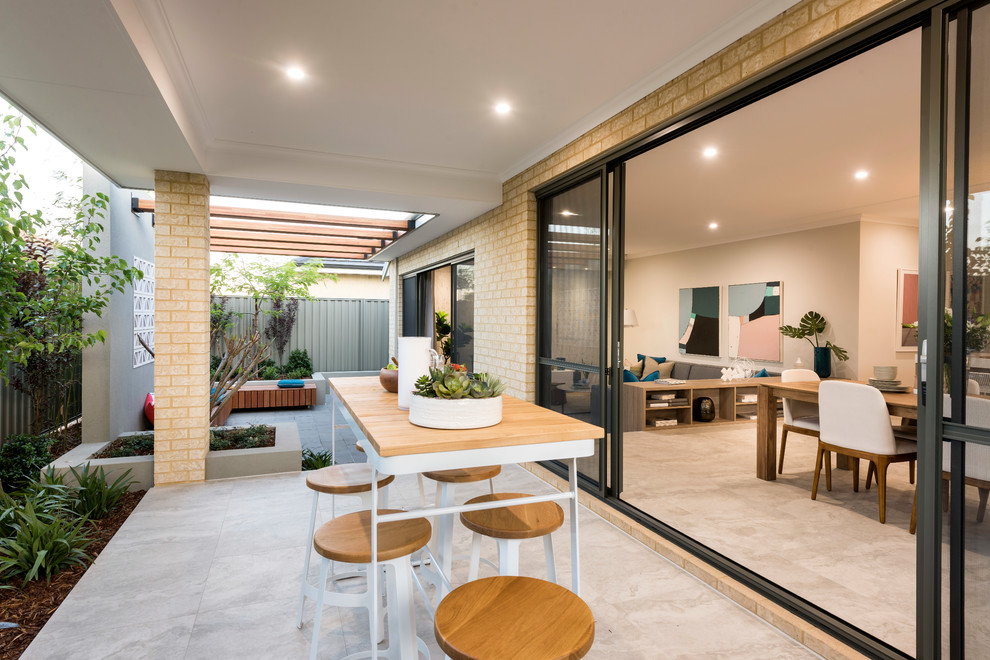 Inspiration for a contemporary backyard patio in Perth with tile and a roof extension.