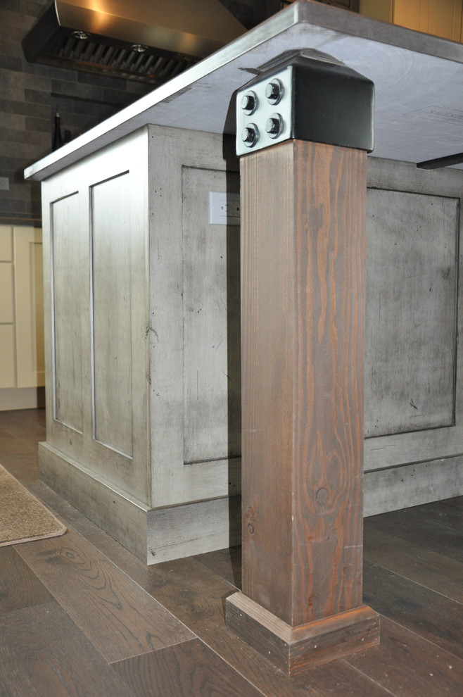 Eat-in kitchen - large rustic l-shaped medium tone wood floor eat-in kitchen idea in Seattle with an undermount sink, shaker cabinets, distressed cabinets, quartz countertops, gray backsplash, stone tile backsplash, stainless steel appliances and an island