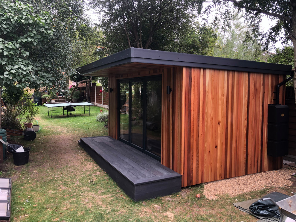 Example of a mid-sized trendy detached studio / workshop shed design in Surrey