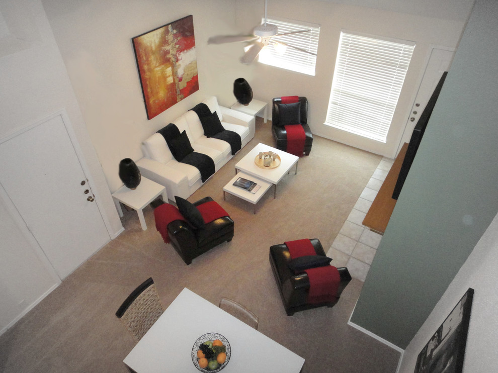 Photo of a small contemporary formal loft-style living room in Houston with beige walls, carpet, a standard fireplace and a wall-mounted tv.