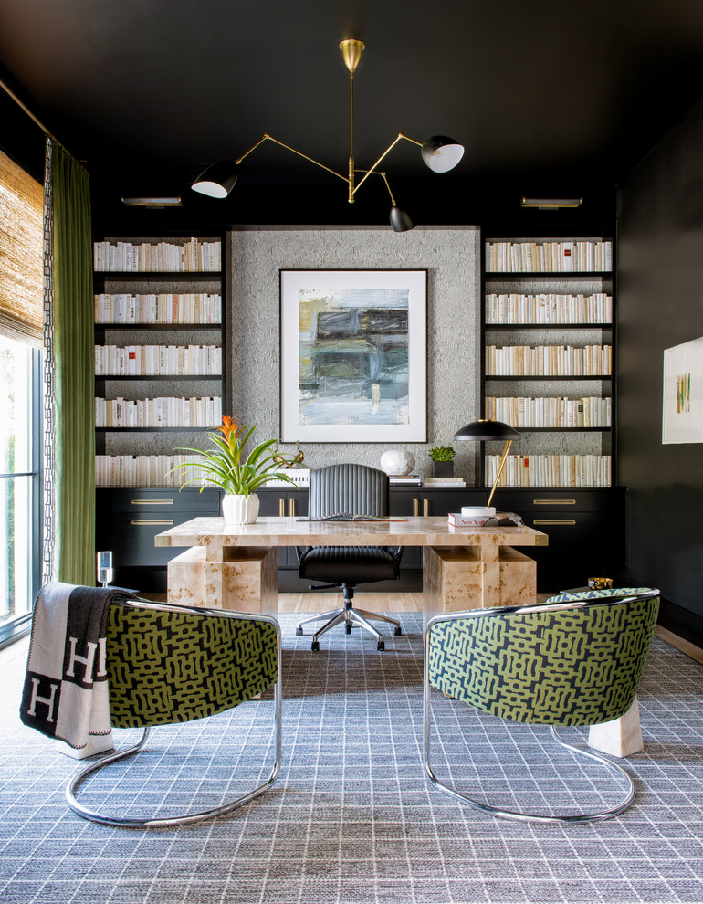 This is an example of a contemporary home office in Dallas with black walls, carpet, a freestanding desk and grey floor.