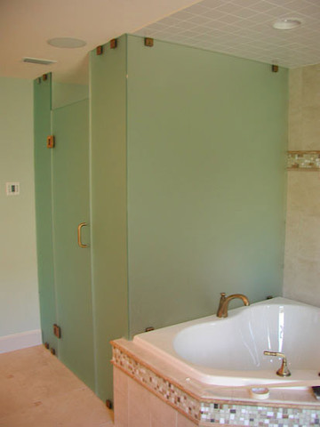 This is an example of a mid-sized tropical master bathroom in Tampa with a drop-in tub, an alcove shower, beige tile, porcelain tile, beige walls and porcelain floors.