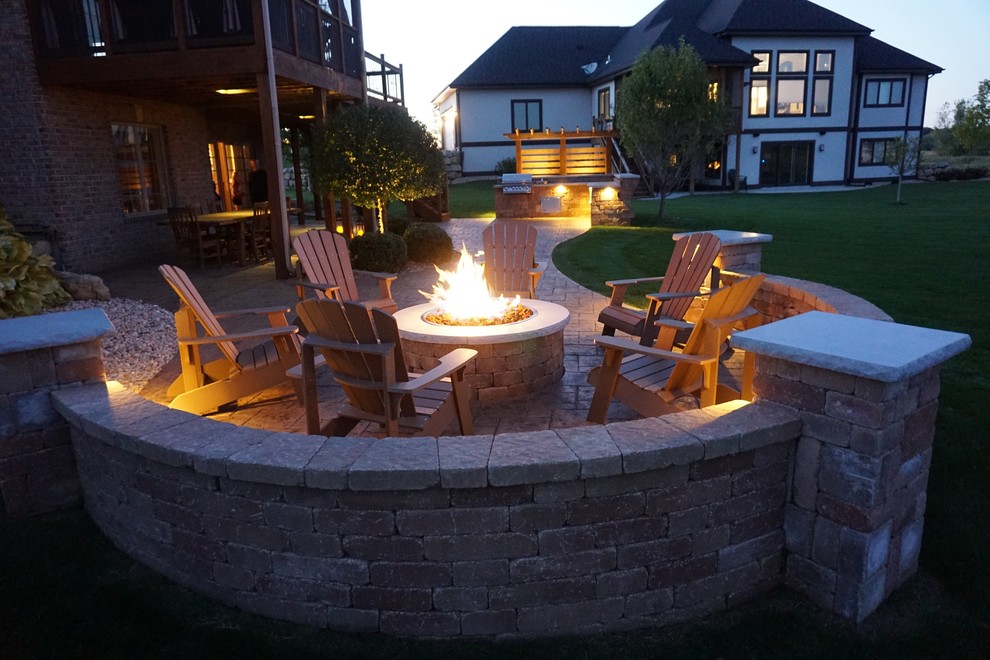 Mid-sized transitional backyard concrete paver patio photo with a fire pit