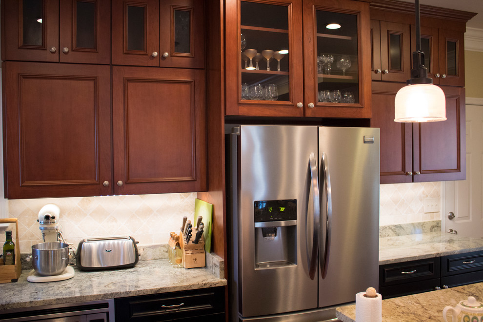 Inspiration for a large transitional l-shaped dark wood floor and brown floor enclosed kitchen remodel in DC Metro with a double-bowl sink, raised-panel cabinets, dark wood cabinets, granite countertops, beige backsplash, limestone backsplash, stainless steel appliances and an island