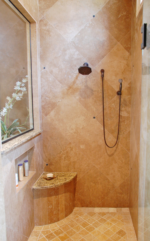 Inspiration for a large mediterranean master bathroom in Orlando with an undermount sink, a drop-in tub, an alcove shower, a two-piece toilet, raised-panel cabinets, black cabinets, granite benchtops, beige tile, ceramic tile, brown walls and ceramic floors.