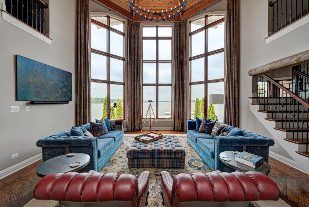 Mid-sized eclectic enclosed medium tone wood floor and brown floor living room photo in Indianapolis with gray walls and a wall-mounted tv