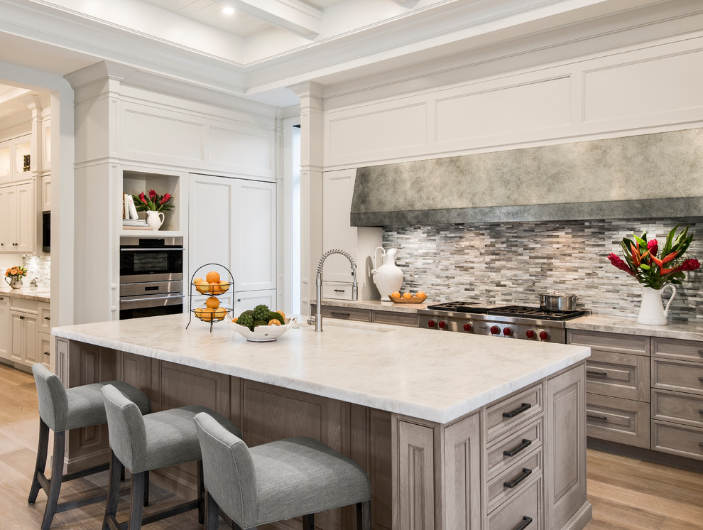 Open concept kitchen - transitional light wood floor open concept kitchen idea with stainless steel appliances and an island