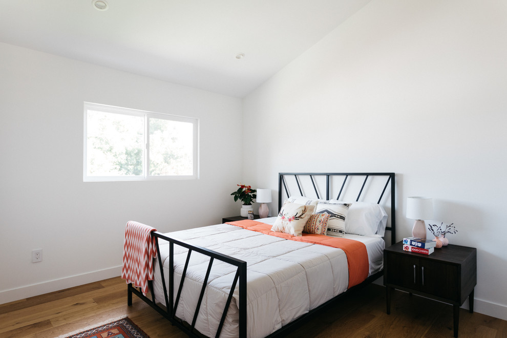 Design ideas for a transitional kids' room for girls in Los Angeles with white walls and light hardwood floors.