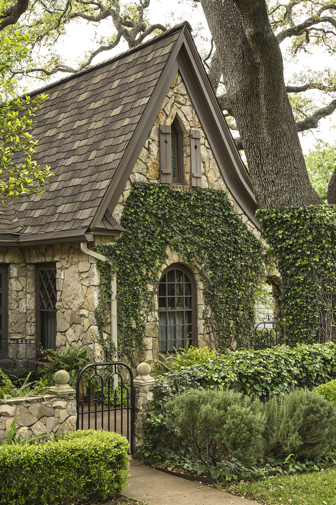 Photo of a large traditional two-storey beige exterior in Austin with stone veneer and a gable roof.