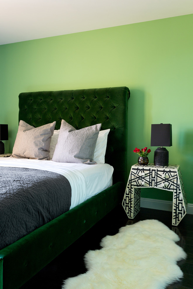 This is an example of a mid-sized transitional bedroom in Los Angeles with green walls.