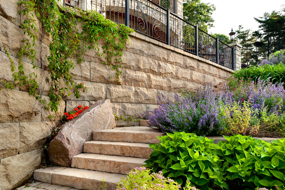 This is an example of a mid-sized rustic backyard retaining wall landscape.