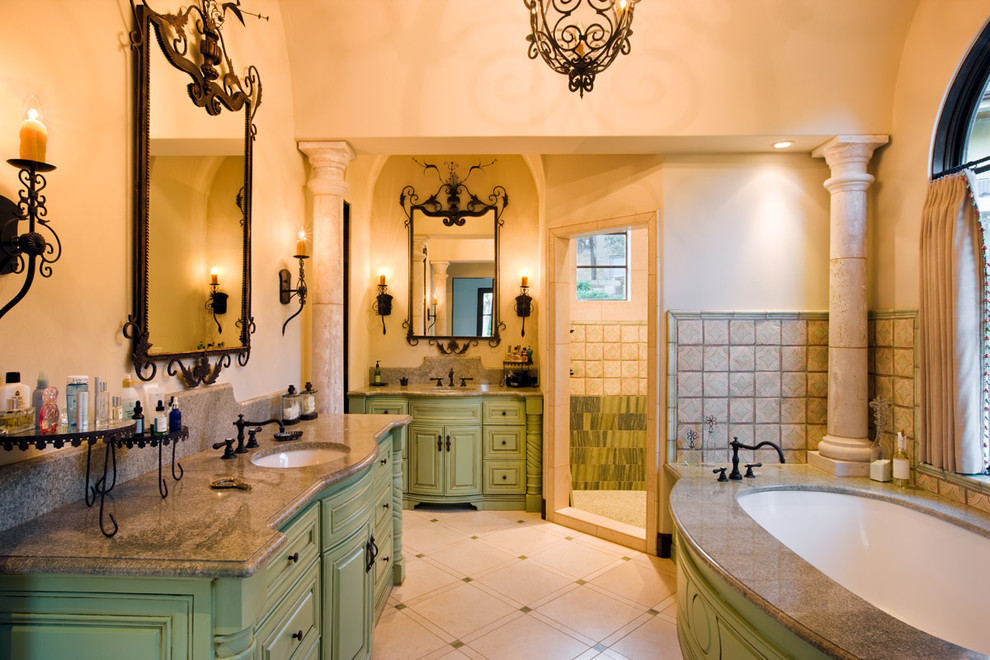 Mediterranean bathroom in Austin with granite benchtops and green cabinets.